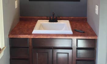 reviewer's dark, brown-colored sink