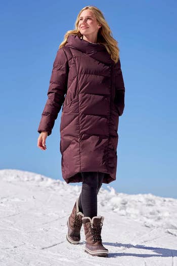 Person wearing a agelong  quilted wintertime  coat, leggings, and snowfall  boots walking connected  snowfall  nether  wide   sky