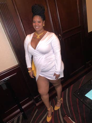reviewer posing in the white wrap dress