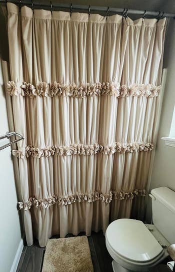 reviewer's beige shower curtain with decorative ruffles