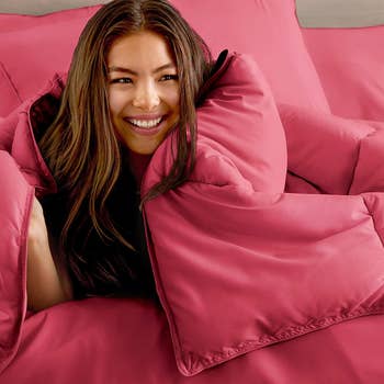 model wrapped in a pink comforter