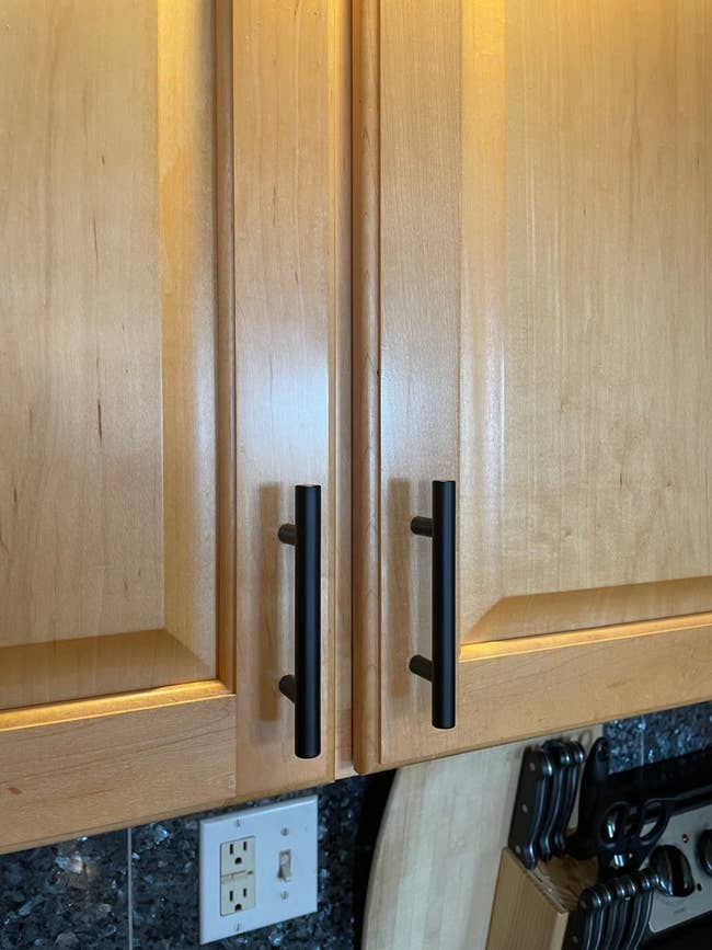 close up of kitchen cabinet with matte black cabinet pulls