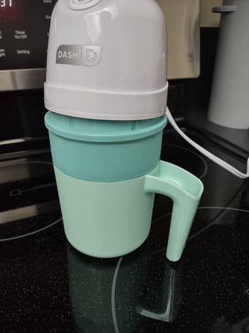 reviewer's single serve ice cream maker with the lid slightly off