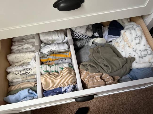 reviewer representation of 1 fractional of a drawer with dividers neatly organizing babe clothes, and the different fractional without dividers and apparel messily thrown in