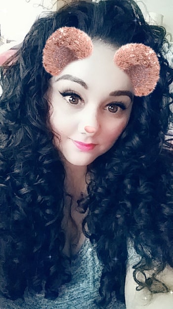 reviewer Snapchat selfie with bear filter, with long black curly hair