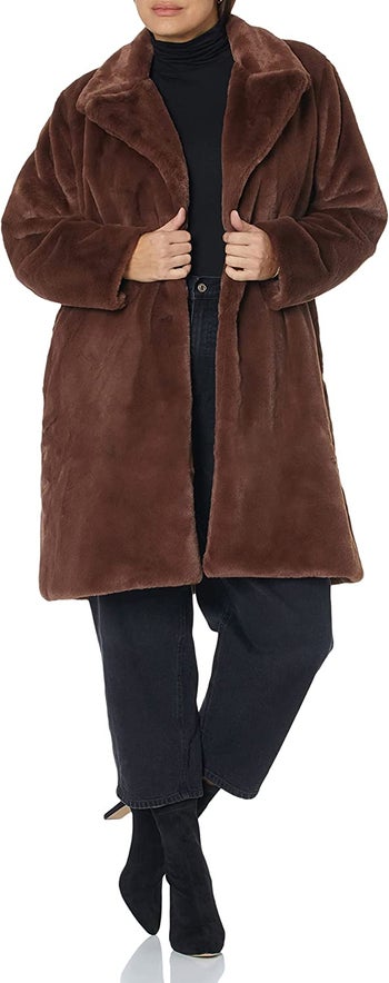 model wearing the faux fur coat in brown