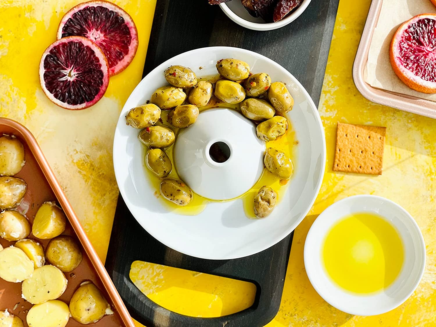 dish with raised center and hole for pits with olives and other foods around it