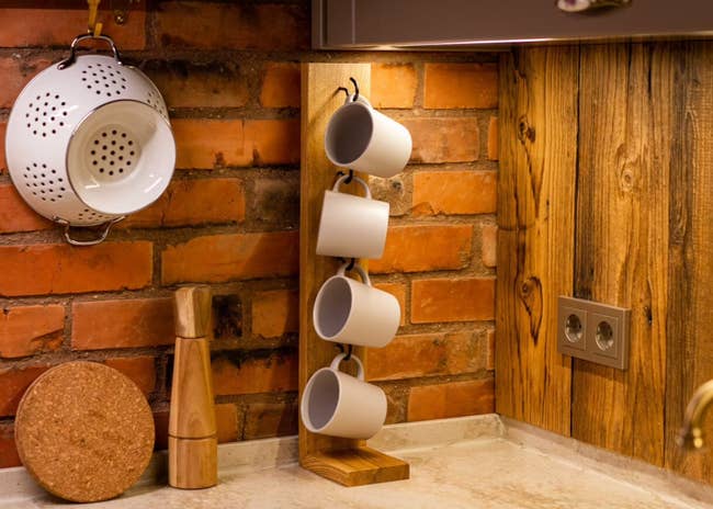 lifestyle photo of wooden mug rack on a kitchen counter