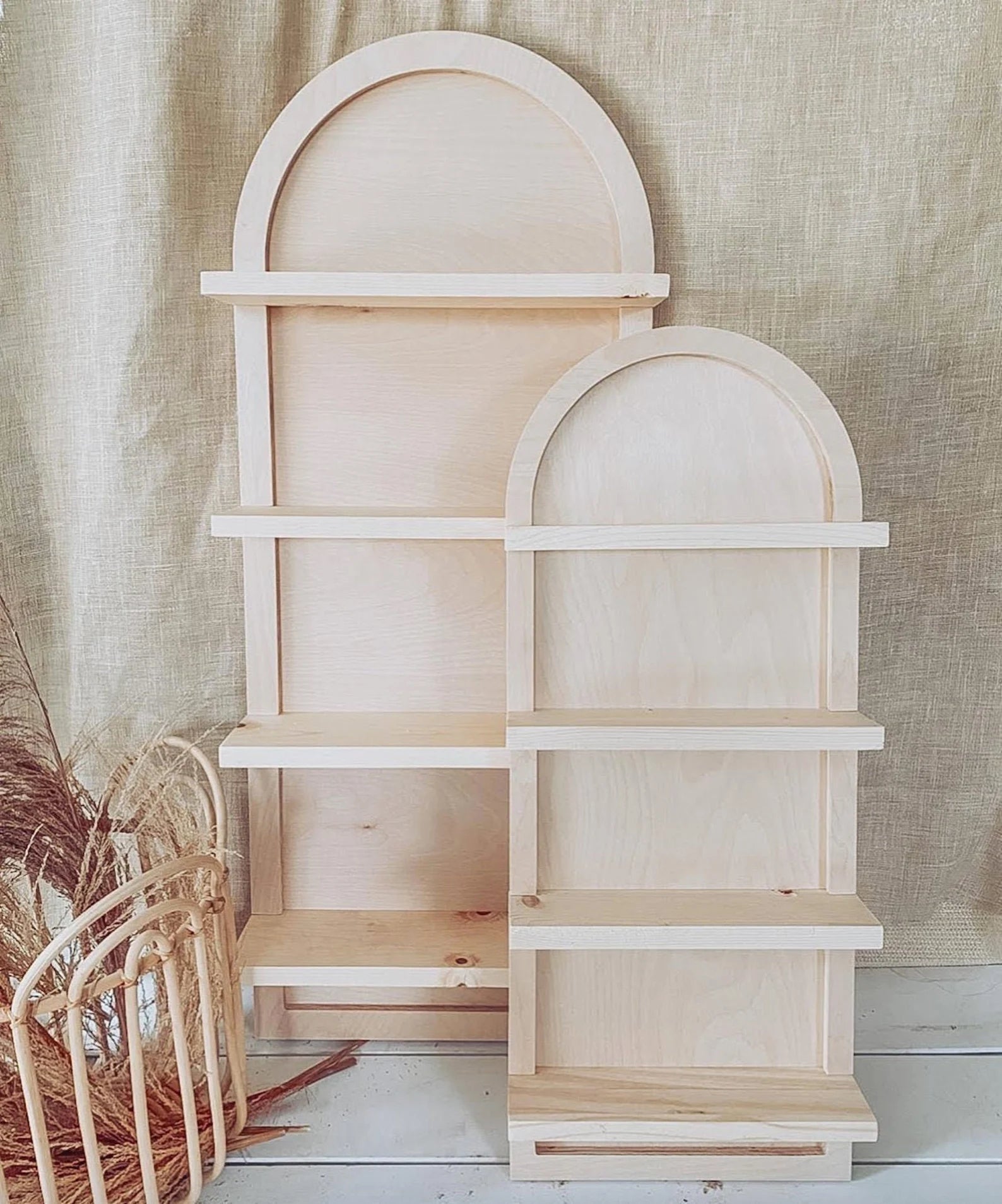 two light wood arched hanging shelves in different sizes