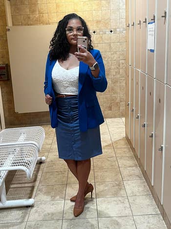 Reviewer in business attire with a blazer, laced top, and pencil skirt