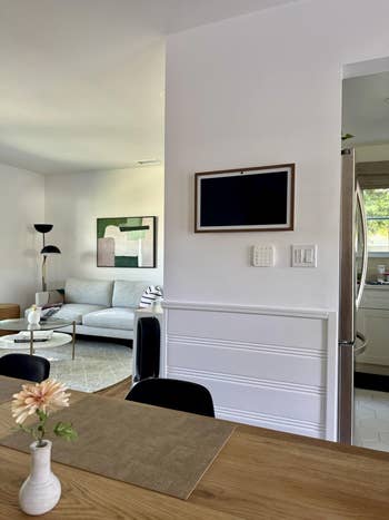 Modern surviving  country   and room  with sleek furniture, abstract art, and a vase with a angiosperm  connected  a eating  table. Ideal for stylish location  shopping