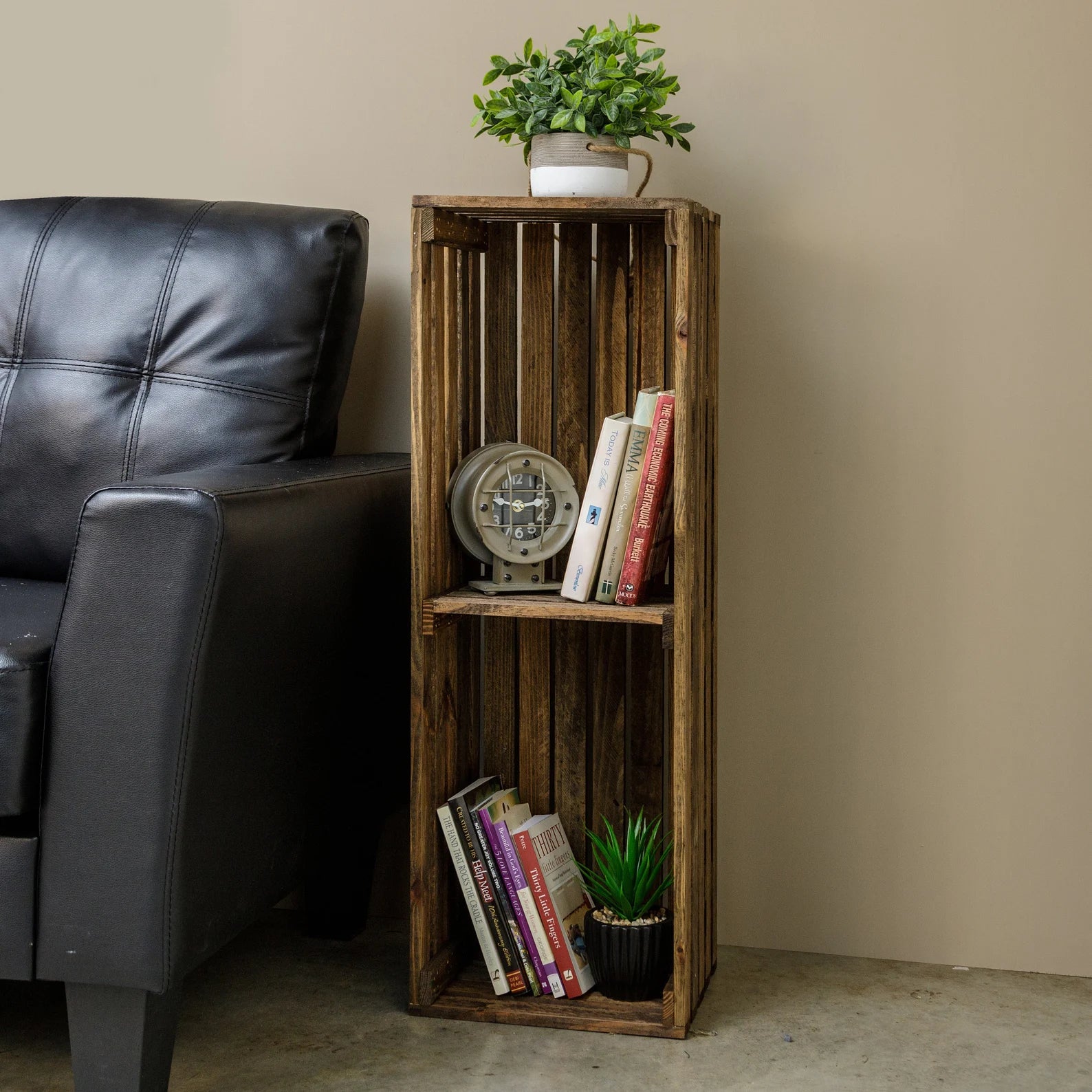 the narrow rustic crate bookcase housing books and tchotchkes