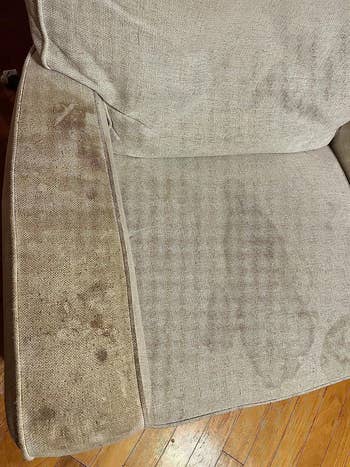 A closeup of a reviewer's chair covered in stains