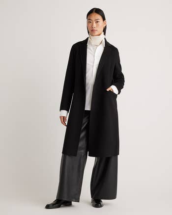model wearing the coat in black open