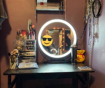 reviewer photo of lit vanity mirror on makeup table