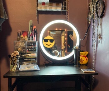 reviewer photo of lit vanity mirror on makeup table