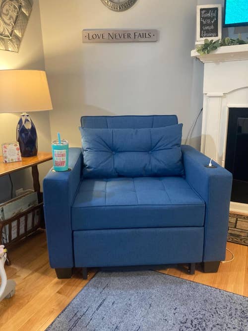 a reviewer's blue chair in the upright position