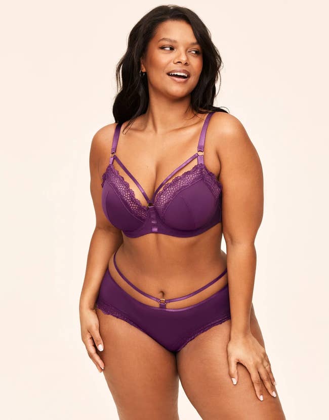 model posing in strappy purple bra and panties
