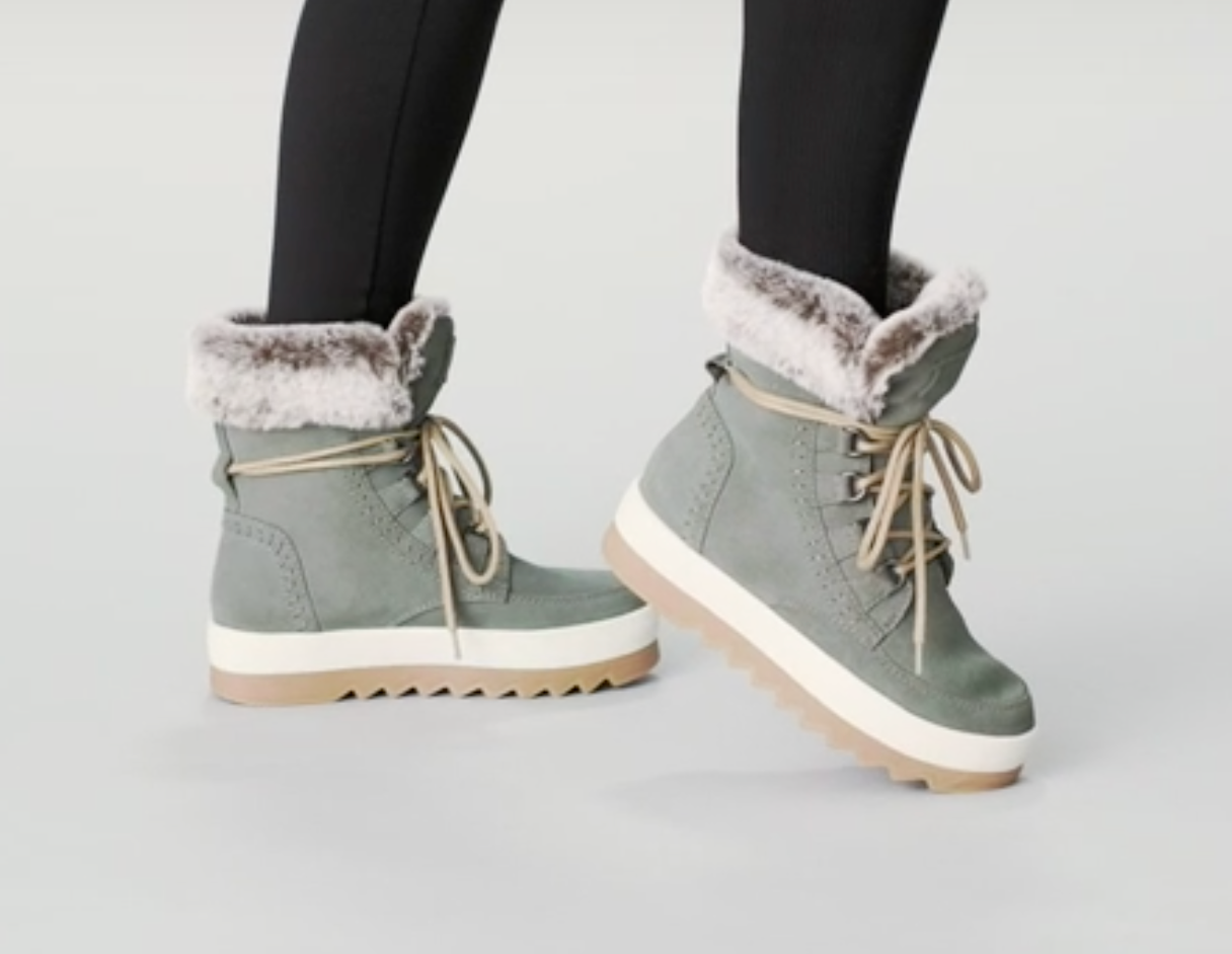 model wearing the boots in grey