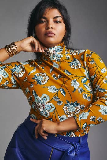 model wearing the yellow floral print turtleneck with blue pants