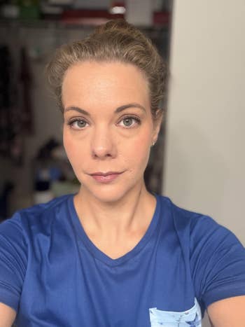 Person with hairsbreadth  successful  a bun wearing a casual T-shirt takes a selfie indoors
