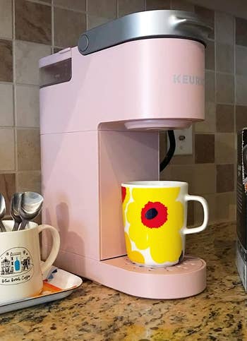 A small slim profile pink Keurig coffee maker 