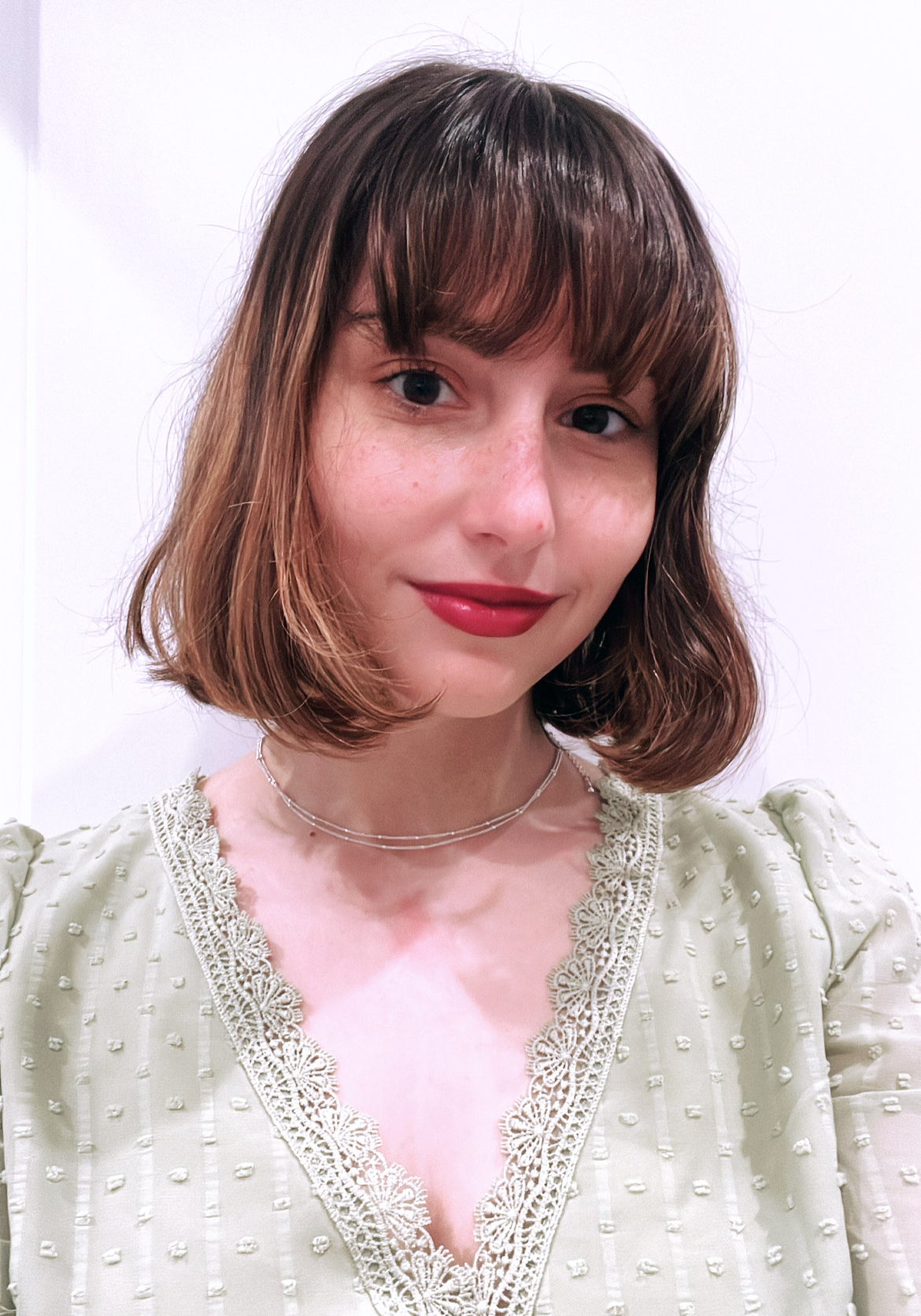 me wearing the Kosas Darkroom red lipstick