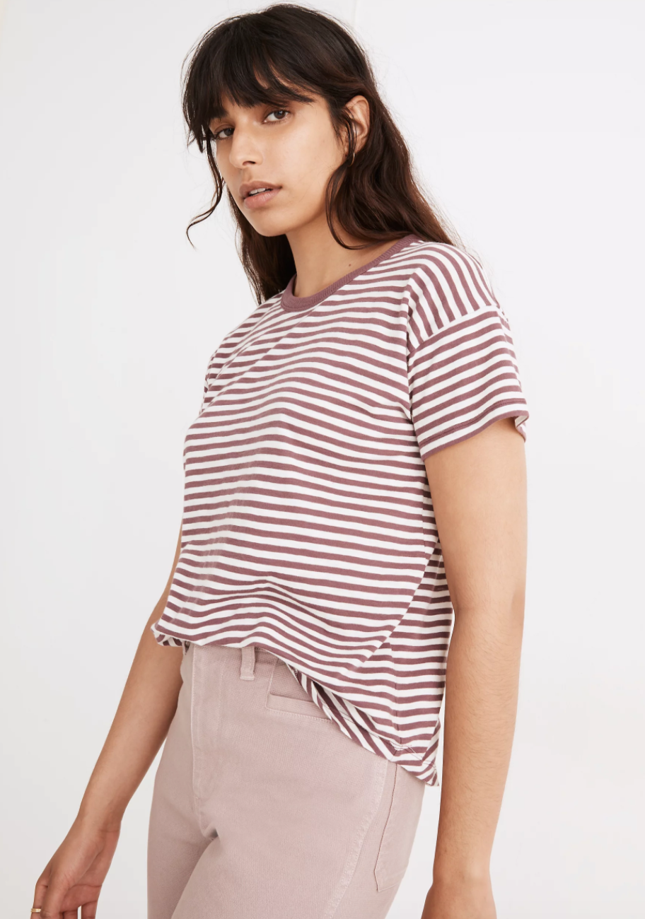 a model in a white tee with horizontal burgundy stripes
