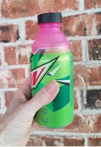 A mountain dew can with a silicone bottle lid hooked up to the stay 