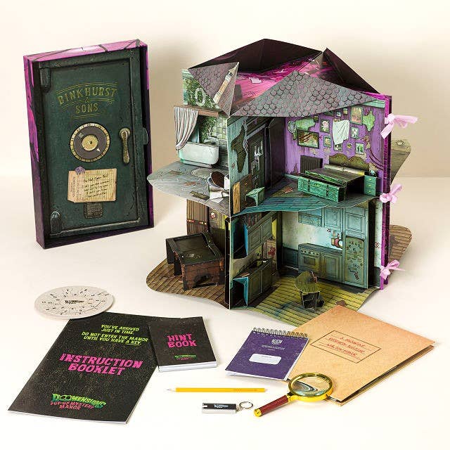 Miniature flight country kit with dollhouse design, includes an acquisition booklet, hint book, pad, magnifying glass, and a safe-themed box