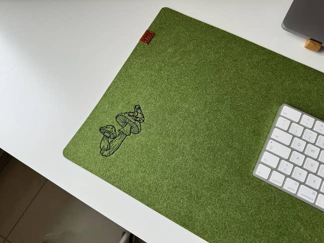 Desktop with a greenish felt table pad