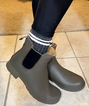 reviewer in the olive-colored waterproof chelsea boots