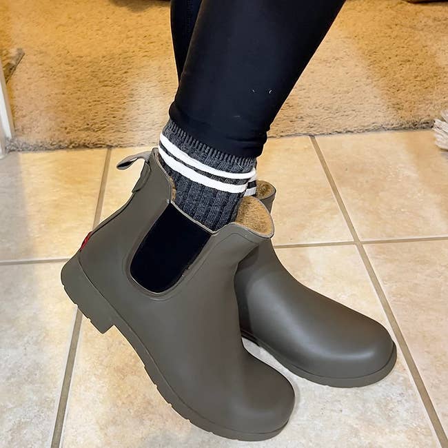 reviewer in the olive-colored waterproof chelsea boots