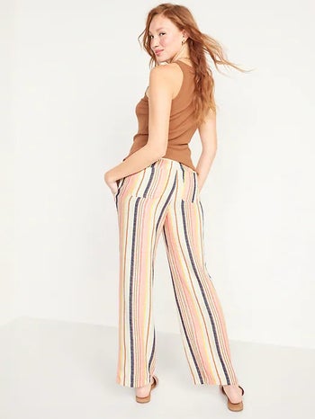 back of model wearing the striped pants