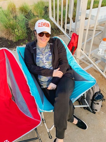 reviewer photo sitting in blue rocker camping chair