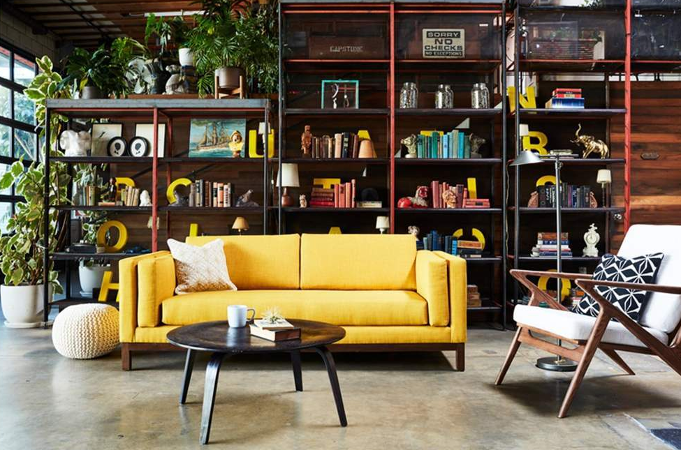 bright yellow sofa with cushioned armrests between the padded frame and seat cushion