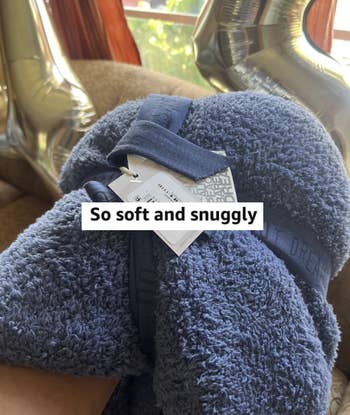 Plush, rolled-up grey broad labeled
