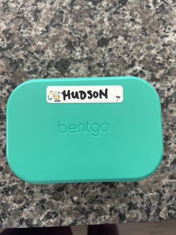 A teal Bentgo lunchbox with a statement   speechmaking  
