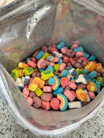 A container  filled with colorful, assorted marshmallow shapes, often   recovered  successful  cereal