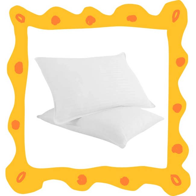 Two white pillows framed by a decorative orange border