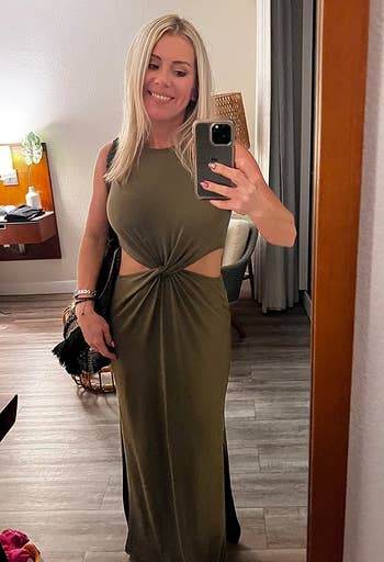 reviewer wearing the olive green dress