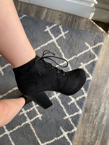 reviewer photo of them wearing a black chunky lace-up bootie