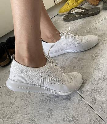side view of the white cole haan sneakers