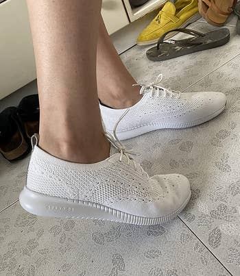 side view of the white cole haan sneakers