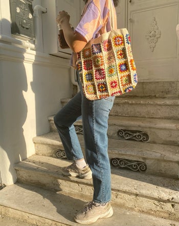 A model wearing the cream tote