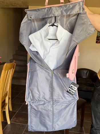 Garment bag rolled open to show shirt hung neatly inside 