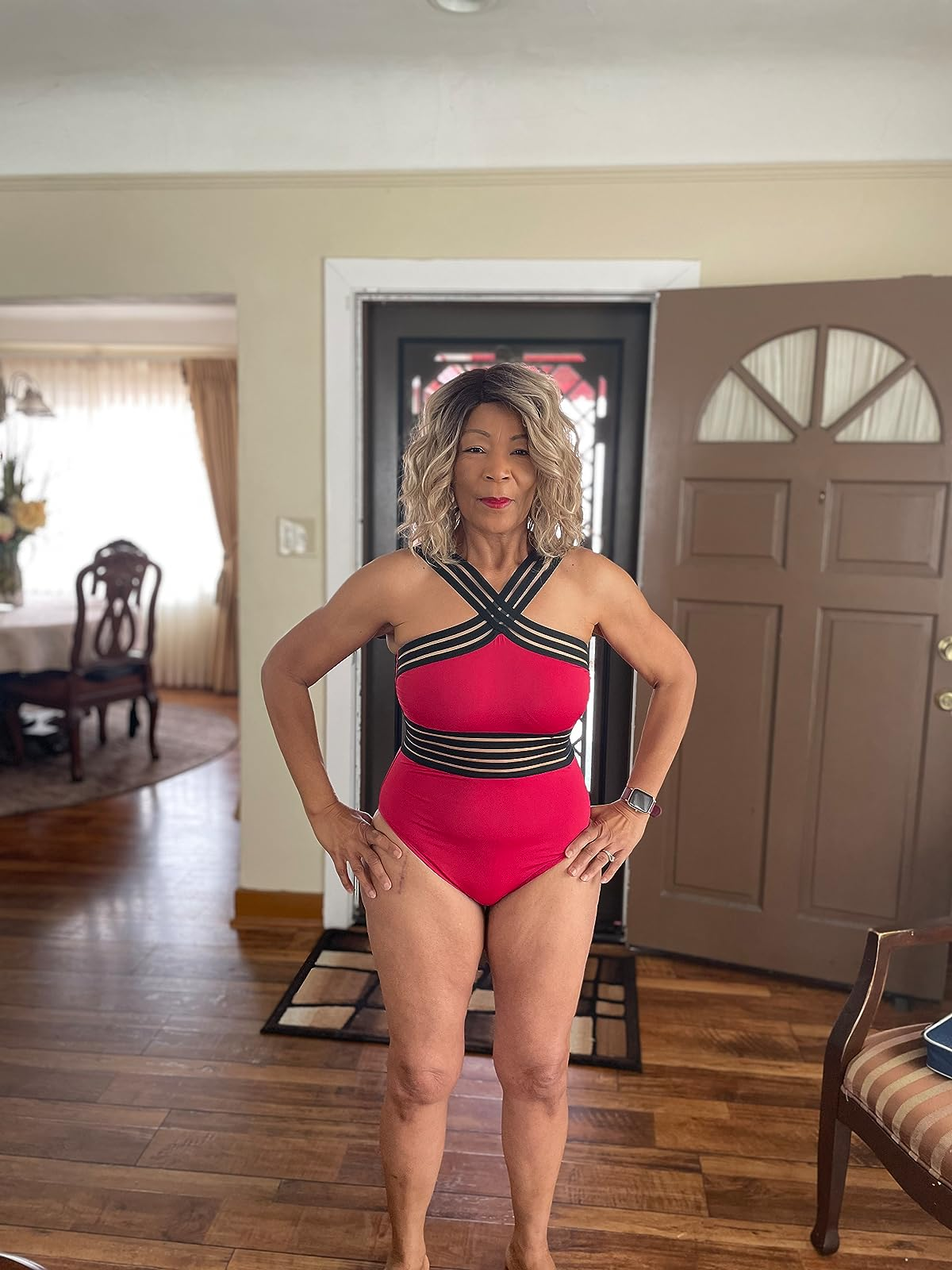 reviewer showing off the red swimsuit
