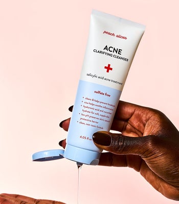 a model squeezing the clear formula in their hand