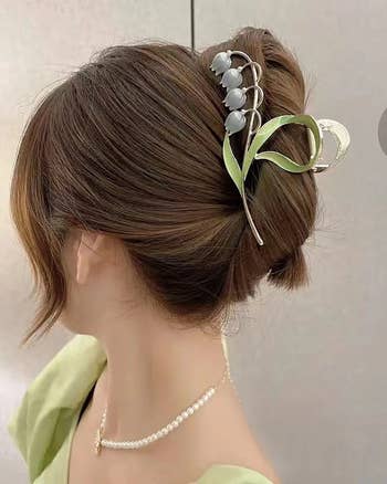 model wearing lily-inspired claw clip