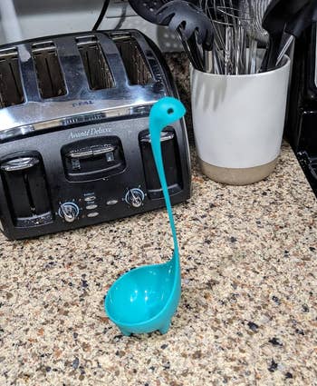 Nessie-shaped room ladle lasting upright